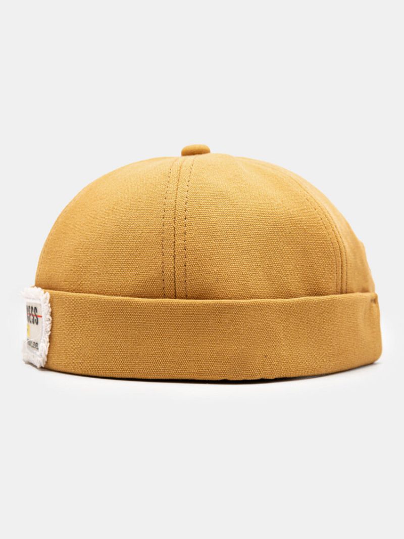 Unisex Polyester Bomull Solide Bokstaver Mønster Råkant-etikett All-match Brimless Beanie Landlord Cap Skull Cap